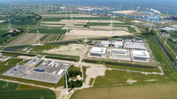 3 June 2022, Eemshaven, Holland. Aerial view of new datacenter of Google Alphabeta near Delfzijl in the province of Groningen. Behind the blue RWE power plant. On the clear horizon sea Waddenzee. door Aerovista Luchtfotografie (bron: Shutterstock)
