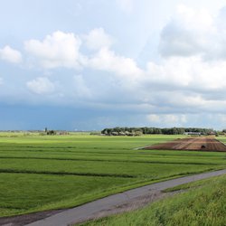 fields and meadows along dyke Hollandsche IJssel river with blue sky and whit clouds. The polder behind the dyke is named zuidplaspolder and the lowest area in the Netherlands with 21ft below sea door Andre Muller (bron: Shutterstock)