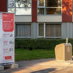 Afvalsorteerregels infobord naast stedelijke ondergrondse vuilnisbakke door Milos Ruzicka (bron: Shutterstock)