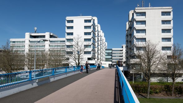 Voetgangersbrug met voetgangers naar groot wit kantoorgebouw (Smedinghuis) van Rijkswaterstaat in Lelystad door T.W. van Urk (bron: Shutterstock)