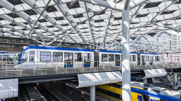 The Hague, The Netherlands - August 6, 2017: Central Train Station The Hague with construction, train, HTM tram, platforms and glass windows. door Daan Kloeg (bron: Shutterstock)