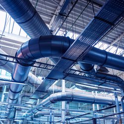 Air conditioning of buildings. Background of ventilation pipes. Laying of engineering networks. Industrial background door Roman Zaiets (shutterstock)